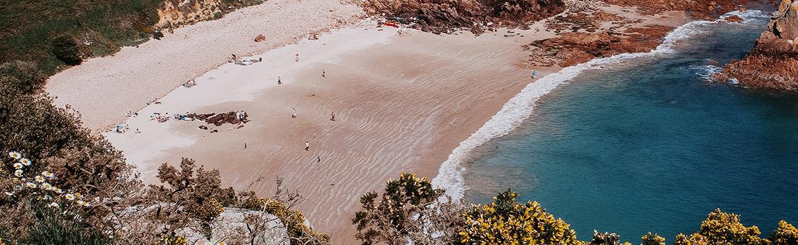 Photo of Beauport bay, summer time, low tide with sea crashing on sand